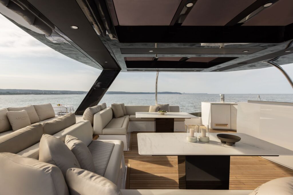 Flybridge lounge with teak deck and sofas aboard Arctic Moon