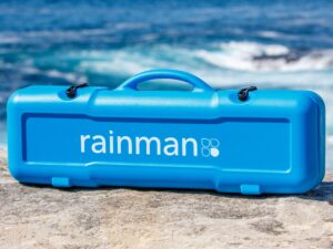 Rainman compact watermaker case on rocks by the sea