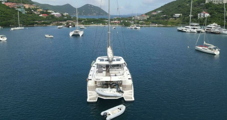 Catamaran at anchor with its tender in a Virgin Islands bay